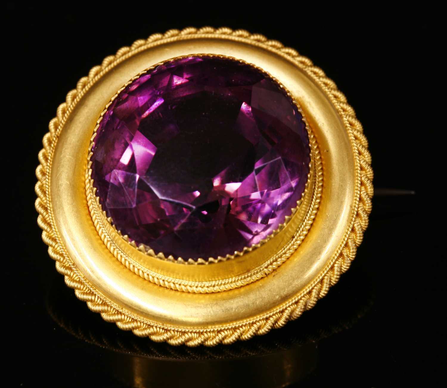 A Victorian gold shield form single stone amethyst brooch,