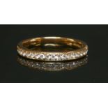 An 18ct rose gold half eternity ring,