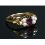 An Edwardian garnet and pearl boat-shaped ring,