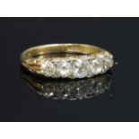 An early 20th century five stone diamond carved head ring,