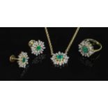 An 18ct gold emerald and diamond cluster pendant necklace, earring and ring matched suite,