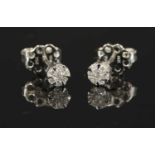 A pair of white gold seven stone diamond cluster earrings,