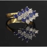 An 18ct gold sapphire and diamond lozenge-shaped cluster ring,