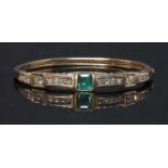 A late Victorian emerald and diamond hinged bangle, c.1880,