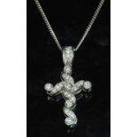 An 18ct white gold diamond set cross and chain,