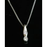 An 18ct white gold two stone diamond pendant,