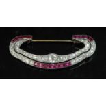A cased Art Deco platinum and gold, ruby and diamond brooch attributed to Chaumet c.1930,