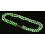 A two row uniform jadeite bead necklace,