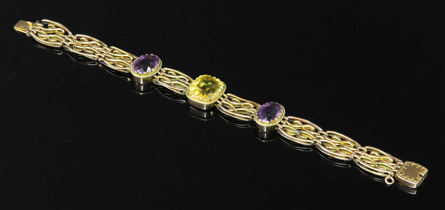 An Edwardian four row citrine and amethyst gate bracelet,