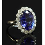 A platinum tanzanite and diamond oval cluster ring,