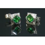 A pair of 18ct white gold tsavorite garnet and diamond square cluster earrings,