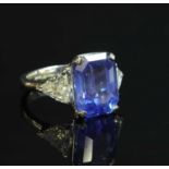 A platinum three stone unheated sapphire and diamond ring,