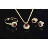 A gold ruby and diamond cluster pendant necklace, earring and ring matched suite,