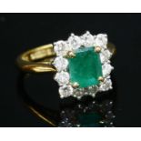 An 18ct gold emerald and diamond rectangular cluster ring,