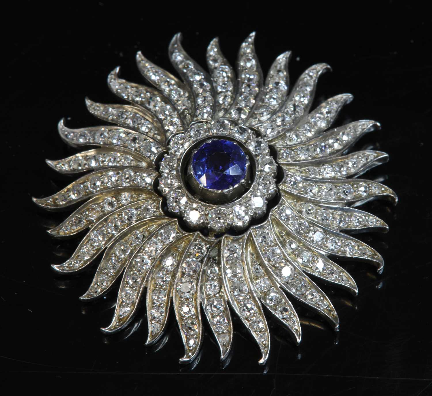 A late Victorian sapphire and diamond sunburst brooch/pendant, c.1890,