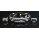 A white gold sapphire and diamond hinged bangle and earring suite,