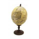 A modern scrimshaw table piece in the form of an ostrich egg,
