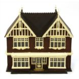 An Edwardian white painted double fronted dolls house,