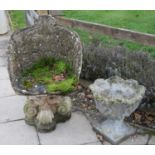 A reconstituted stone garden chair in the rococo style,