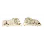 A pair of modern composition figures of lions,