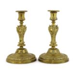 A pair of Louis XV cast brass candlesticks,