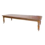 A reproduction mahogany extending dining table,