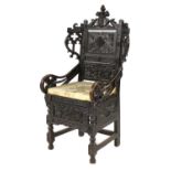 A carved oak elbow chair,