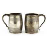 A pair of George III silver mugs