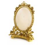 A giltwood table mirror,