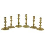 Three pairs of 17th and 18th century brass candlesticks,