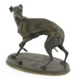 A bronze model of a whippet with a ball,