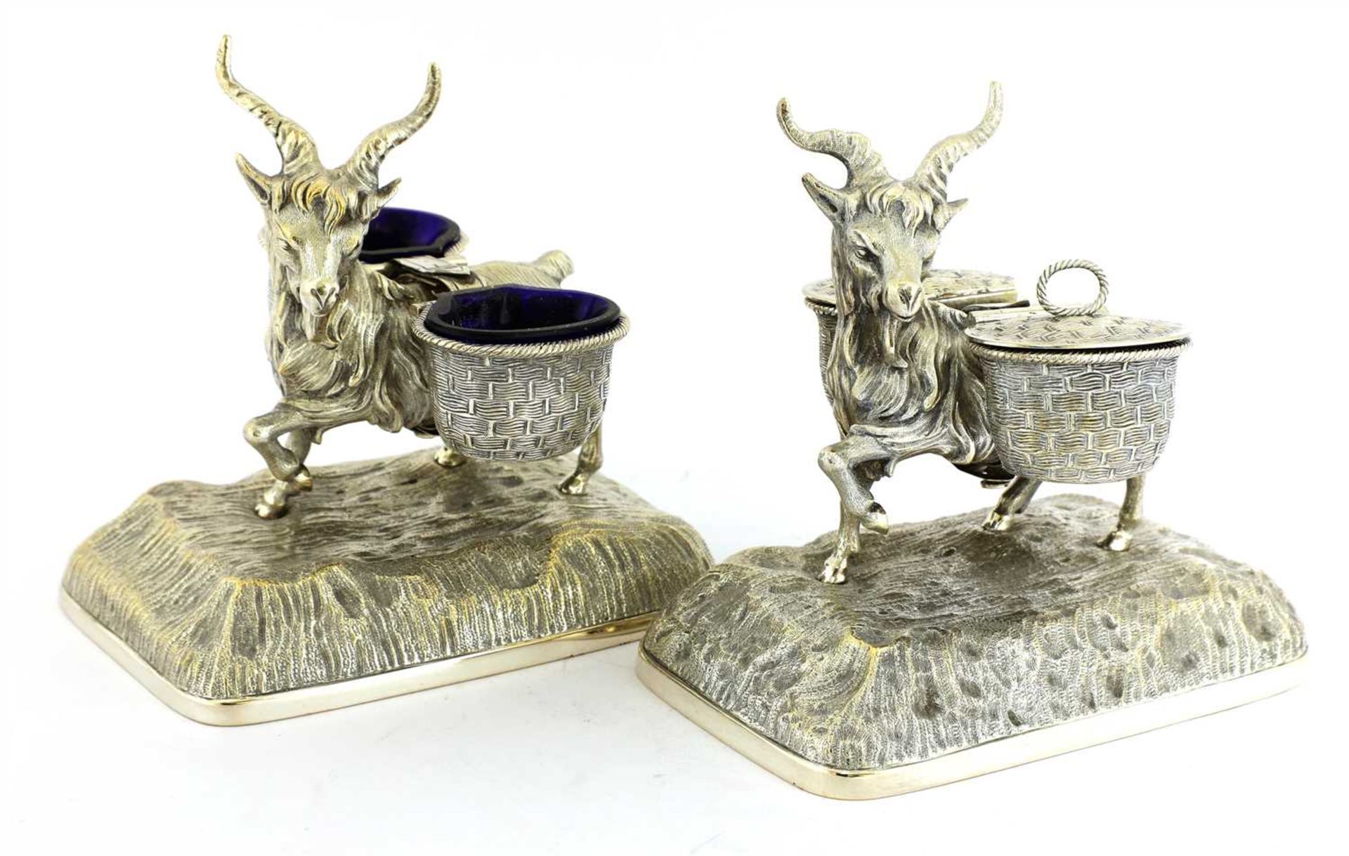 A pair of silver-plated cruets in the form of goats,