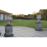 A pair of cast iron urns,