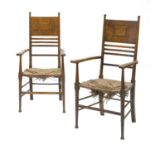 A pair of Arts & Crafts oak open armchairs,