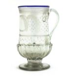 A glass coin tankard,