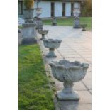 A set of eight reconstituted stone garden urns,