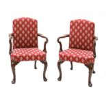 A pair of reproduction mahogany elbow chairs,