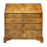 A walnut, crossbanded and chevron strung bureau,