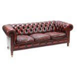 A modern red leather three-seat Chesterfield,