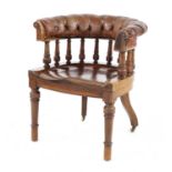 A mahogany and leather upholstered desk chair,