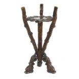 A carved walnut Black Forest jardiniere stand,