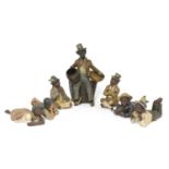 Seven various 19th century and later terracotta blackamoor and other figures,