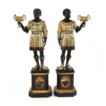 A pair of Venetian carved ebonised and polychrome painted blackamoors,