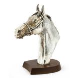 A silver trophy in the form of a horse head,