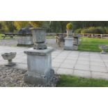 A pair of composition stone urns,
