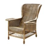 A large wicker spoon back armchair,