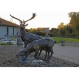A large bronze figure group of a stag and a doe,