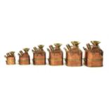 A complete set of six graduated copper and brass banded petrol 'standard' measures,