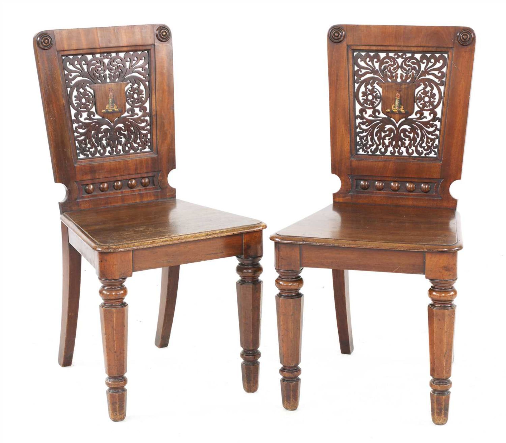 A pair of mahogany hall chairs,