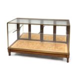 A brass and glazed shop display cabinet,
